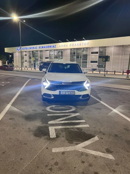 White Kia Sportage automatic 4x4 SUV at Kefalonia Airport at night, front view